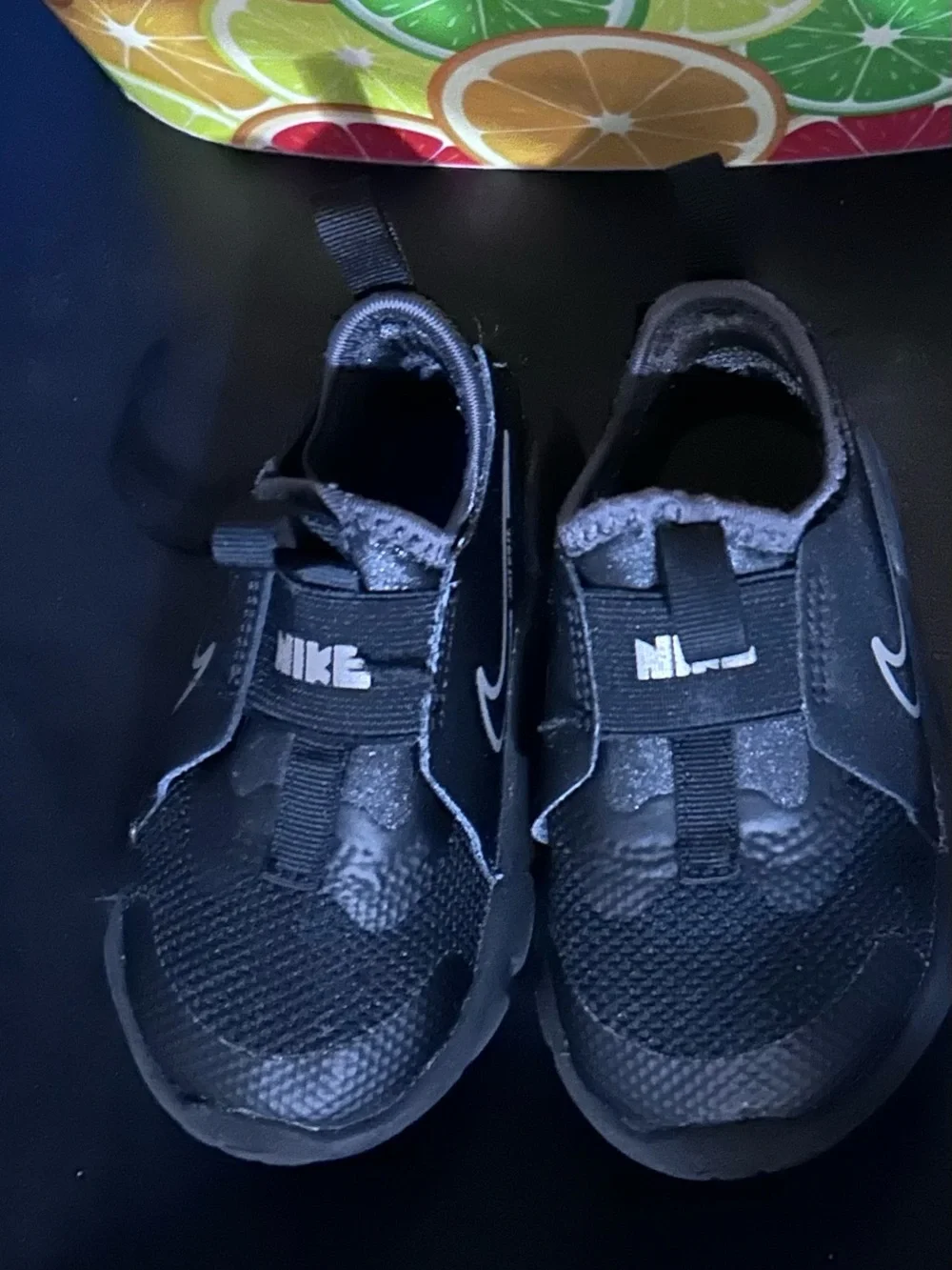 Nike Youth Black Slip-On Sneaker with White Swoosh and Blue Insole